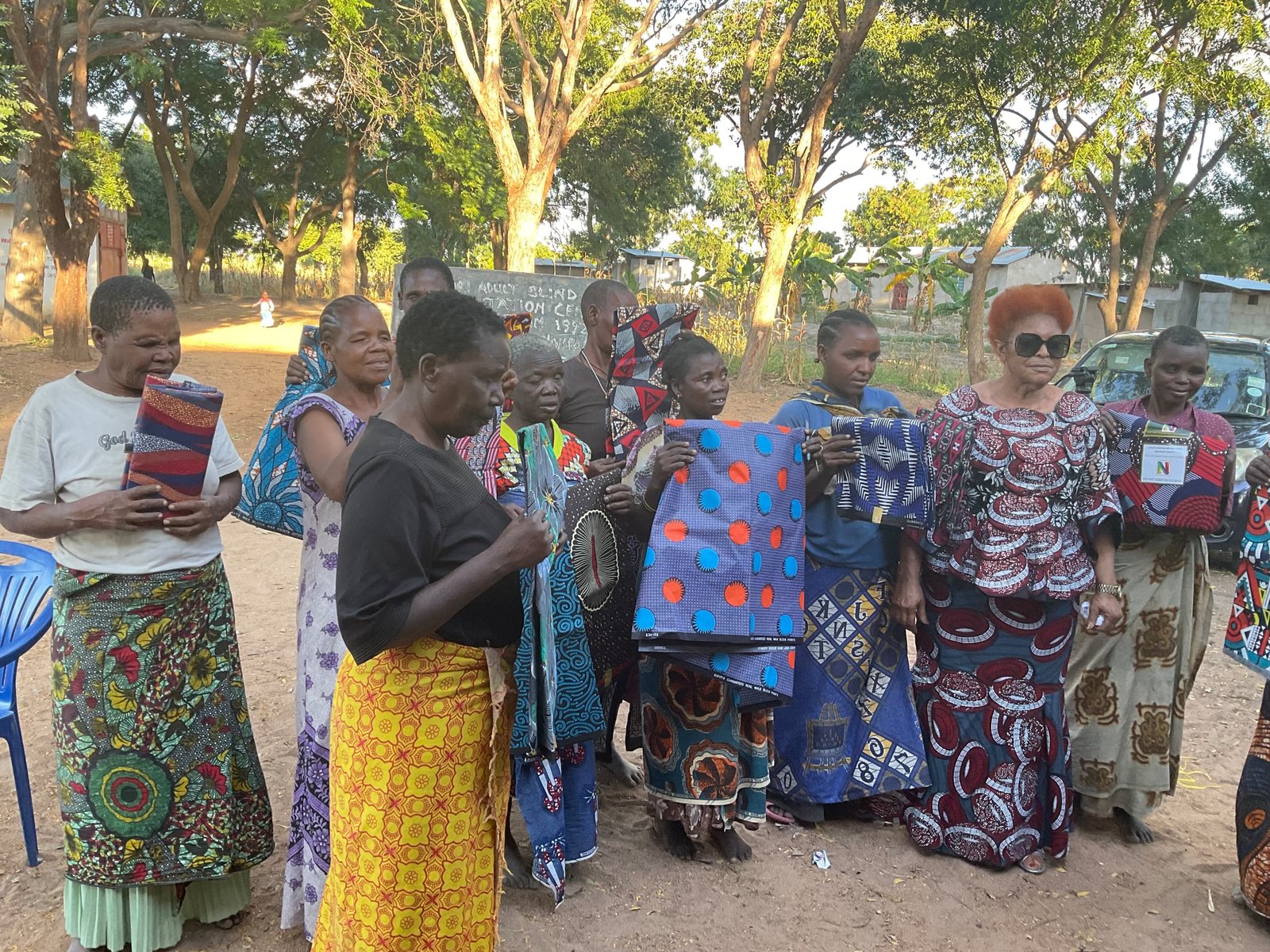 Community members with donated fabrics during outreach