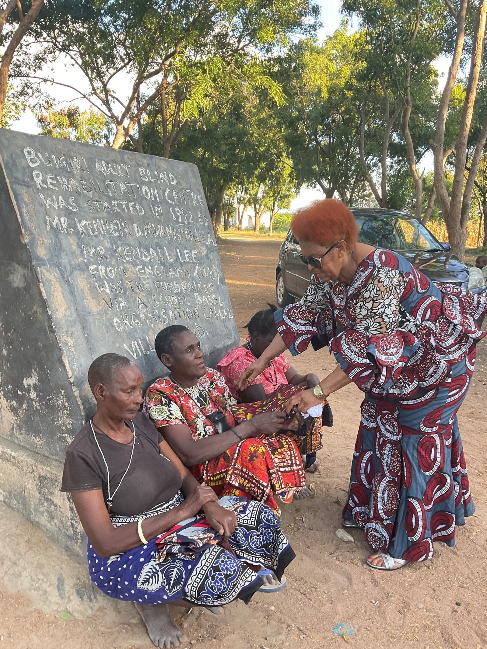 Volunteer handing fabric to community member