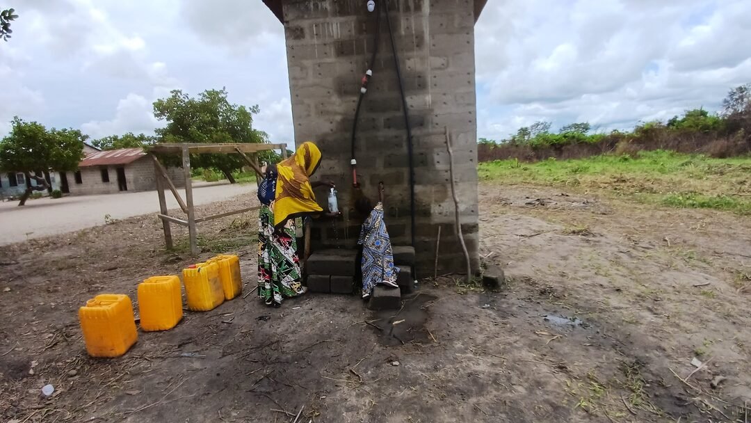 Women collecting water at the community water point